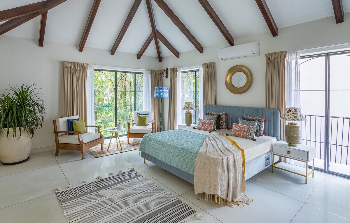 Master bedroom with wooden-beam ceiling at AMOR